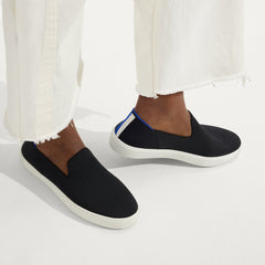 hover | The Original Slip On Sneaker in Black Solid shown on-model at an angle.