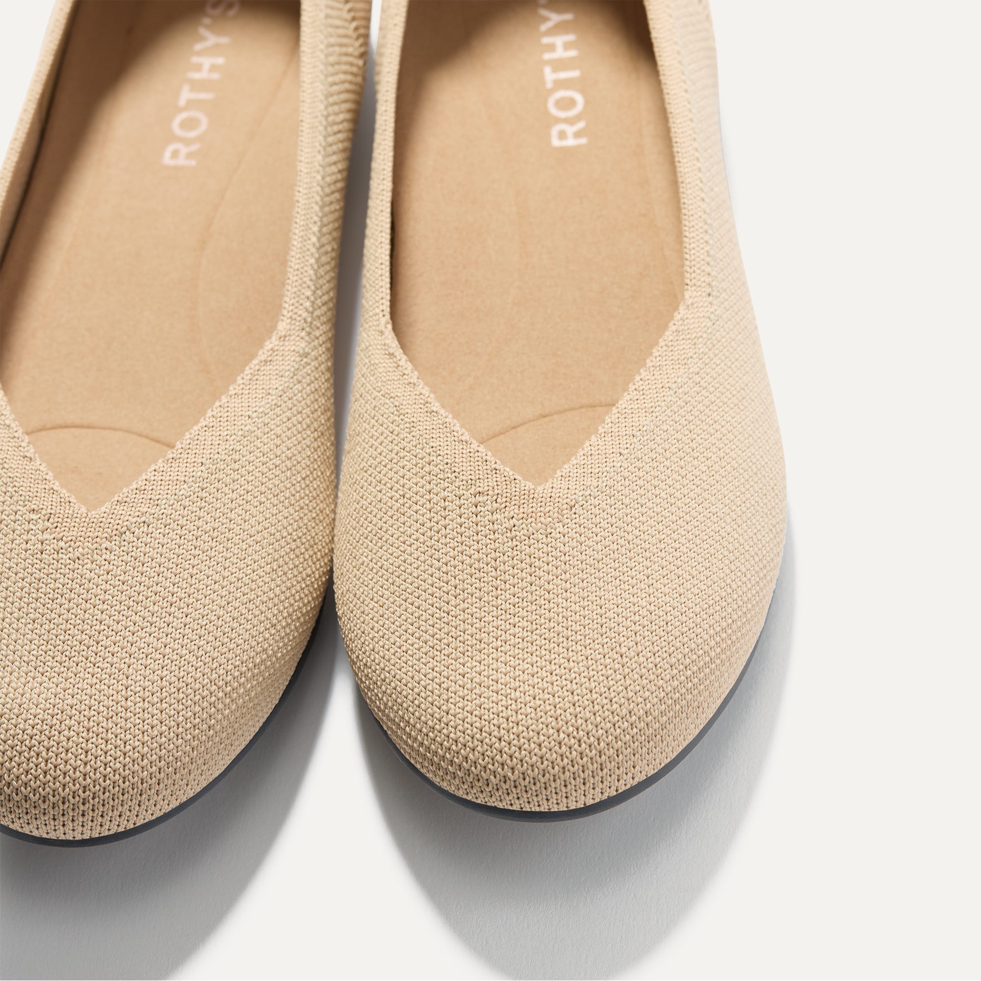 Close up of the toe and vamp of The Daily Flat in Ecru. 