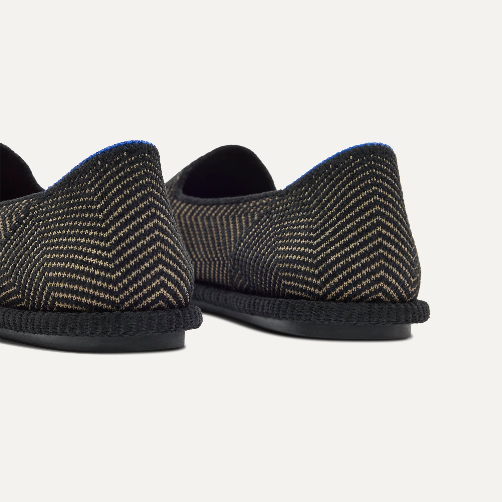 Close up of the heel of The Cruiser Loafer in ReVelvet Jet Herringbone, with Rothy's signature blue halo. 