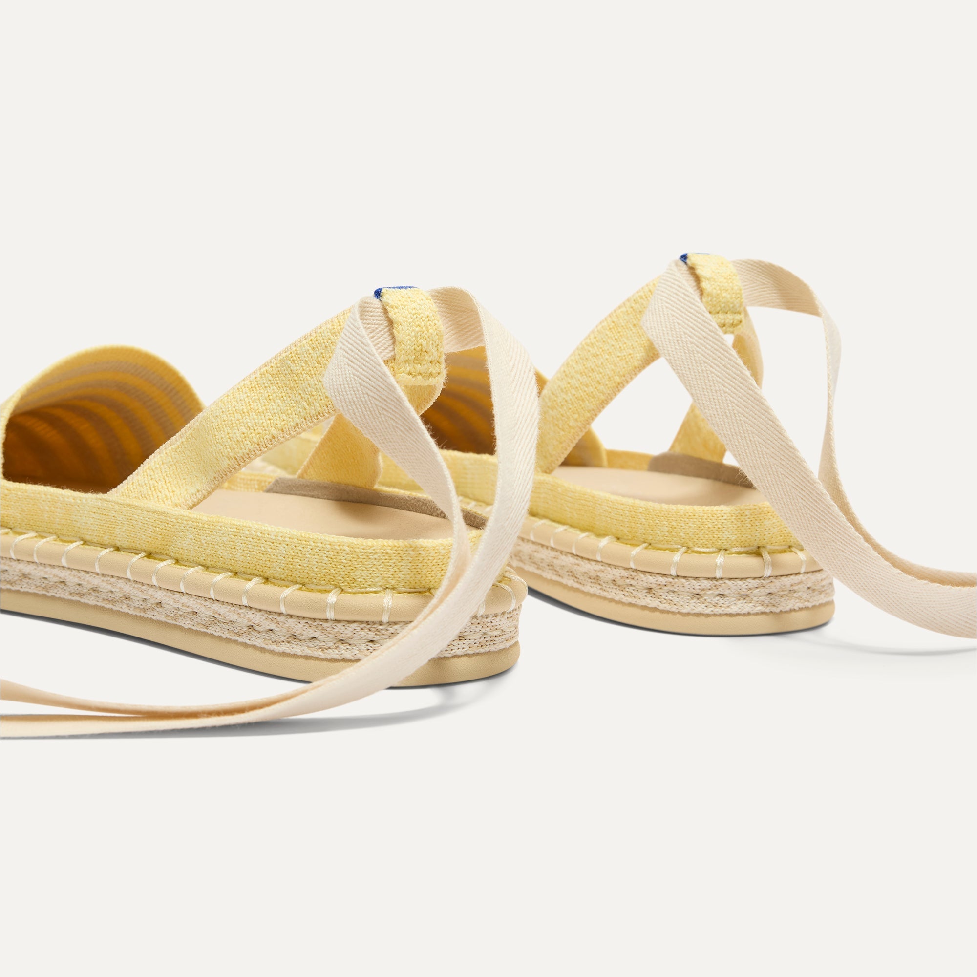 Close up of the heel of The D'Orsay Espadrille in Sunshine Stripe, showing removable ankle straps.
